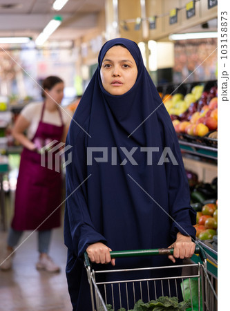 Portrait of young woman shopper in hijab in supermarket 103158873