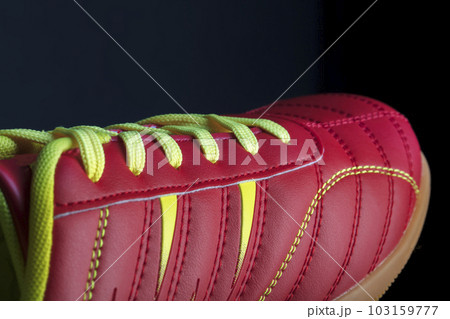 The texture of a red sneaker closeup. Part of leather sports shoes 103159777