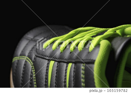 Fragment of a black sneaker closeup. Part of leather sports shoes 103159782