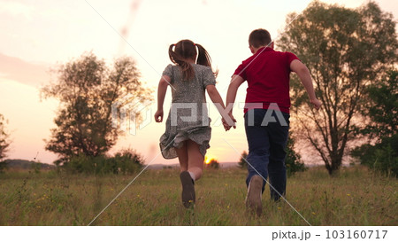 happy childhood, children legs green lawn, children run forest park sunset, children's legs run green grass park, childhood friendship concept, teamwork, hold hand, girl boy team, play sister brother 103160717