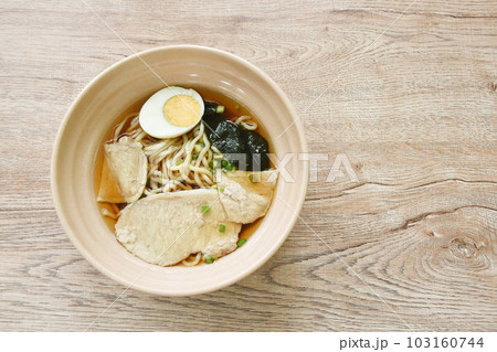 shoyu ramen or Japanese yellow noodles topping slice braised pork and boiled egg  in soy sauce soup on bowl 103160744