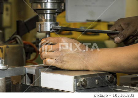 The machine operator change the tool at NC milling machine. The machine operator change the tool at NC milling machine. 103161832