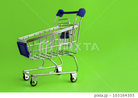 Shopping cart on a green background. Shopping cart on a green background. 103164305