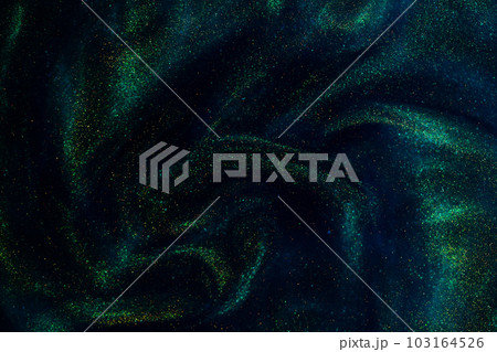 Gold Particles In Blue Fluid. Golden sparkling dust particles floating in a blue liquid with green tints, creating fantasy curved patterns and waves. Magic glittering galaxy. Gold Particles In Blue Fluid. Golden sparkling dust particles floating in a blue liquid with green tints, creating fantasy curved patterns and waves. Magic glittering galaxy. 103164526