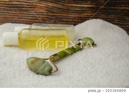 Jade roller and jars of cosmetics Jade roller and jars of cosmetics 103164809