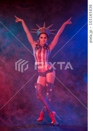 Young woman in stage costume of striptease dancer posing Young woman in stage costume of striptease dancer posing 103165836