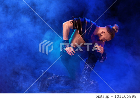 Handsome young sexy man with beautiful muscular chest in interesting costume on the scene 103165898