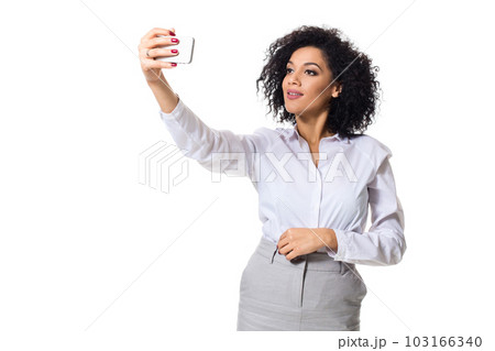 Beautiful brunette woman in classic white shirt and skirt make selfie on the phone. Beautiful brunette woman in classic white shirt and skirt make selfie on the phone. 103166340