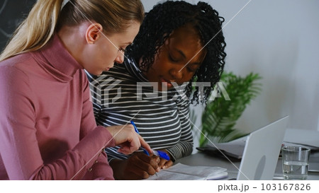 Confident pretty Indian employee talking to business colleague at shared workplace. Female mentor teaching intern, telling about work project. Manager and client discussing online product at laptop Confident pretty Indian employee talking to business colleague at shared workplace. Female mentor teaching intern, telling about work project. Manager and client discussing online product at laptop 103167826
