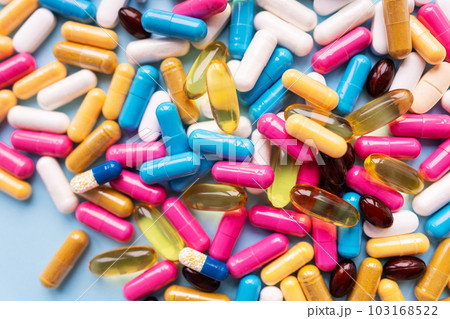 Lots of colorful pills and capsules for different symptoms. Concept of health and medicine. 103168522