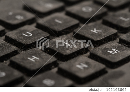 old black keyboard with keys covered in dust and dirt isolated on white background 103168865