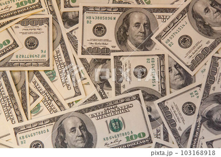 Many hundred dollar bills on the table. One hundred US dollar bills background. U.S. dollars. Banking and finance signs. Much money background. Top view. Close-up 103168918