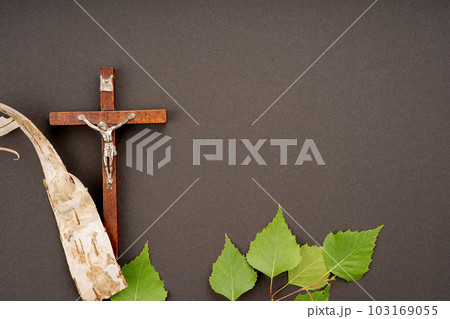 Christian Pentecost. Whit Sunday. A cross with a birch branch on a white, green, red and black background. Christian Pentecost. Whit Sunday. A cross with a birch branch on a white, green, red and black background. 103169055