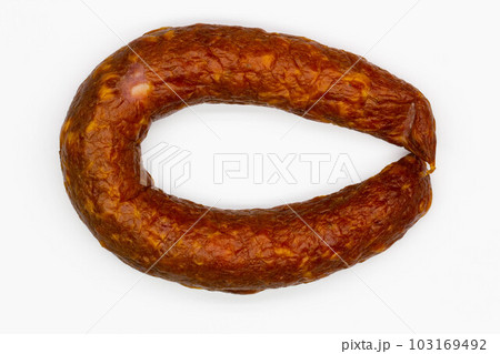 Sausage on a white background. Isolated. Juicy pork sausage with bacon in a beautiful bagel. Fresh homemade beef sausage. Delicious meatloaf with spices. Eco Food. Lamb product. Close-up. Top view Sausage on a white background. Isolated. Juicy pork sausage with bacon in a beautiful bagel. Fresh homemade beef sausage. Delicious meatloaf with spices. Eco Food. Lamb product. Close-up. Top view 103169492