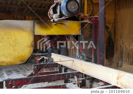 Industrial sawing of wood. Sawing and processing boards at the sawmill. Timber industry 103169810