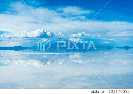 Uyuni Salt Flats. Altiplano, Bolivia. Rainy Season. Tunupa Volcano. Clouds Reflection on Water in Uyuni Salt Flats. Altiplano, Bolivia. Rainy Season. Tunupa Volcano. Clouds Reflection on Water in 103170058