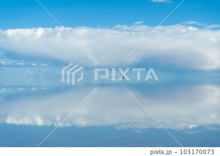 Car at Uyuni Salt Flats. Altiplano, Bolivia. Rainy Season. Tunupa Volcano. Clouds Reflection on 103170073