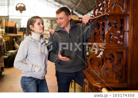 Couple selecting furniture in furnishing salon 103174308