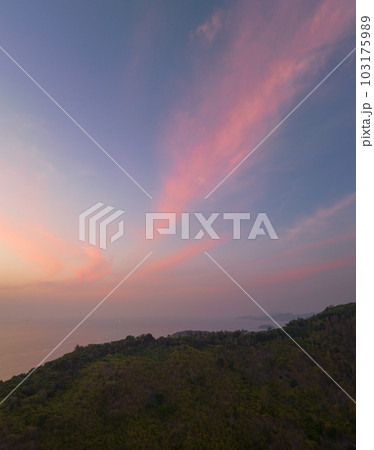 aerial view the sun going down in colorful sky impact on ocean surface The beauty of the cliff fits perfectly with the charming nature in beautiful sunset. cloud scape background aerial view the sun going down in colorful sky impact on ocean surface The beauty of the cliff fits perfectly with the charming nature in beautiful sunset. cloud scape background 103175989