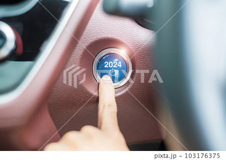 Finger press a car ignition button with 2024 START text inside  automobile. New Year New You, forecast, resolution, motivation, change, goal, vision, innovation and planning concept 103176375
