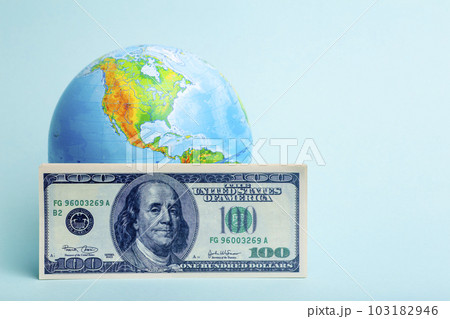 Dollars money on the background of the world globe. Economy, business, crisis concept. Dollars money on the background of the world globe. Economy, business, crisis concept. 103182946