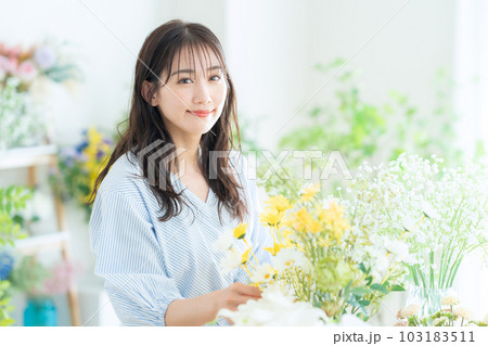 フラワーショップで働く若い女性の店員 フラワーショップで働く若い女性の店員 103183511