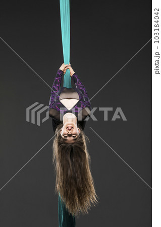 Teenage girl (14-15) during aerial silk practice 103184042