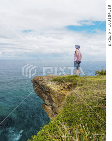Australia, New South Wales, Port Macquarie, Woman standing on cliff and looking at view Australia, New South Wales, Port Macquarie, Woman standing on cliff and looking at view 103184119