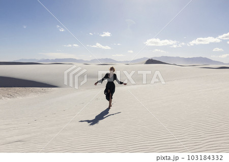 United States, New Mexico, White Sands National Park, Teenage girl walking United States, New Mexico, White Sands National Park, Teenage girl walking 103184332