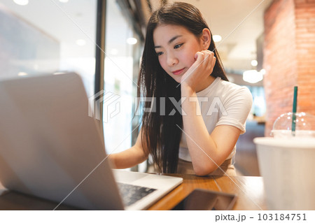 Business freelance asian woman using laptop computer at cafe urban lifestyle 103184751