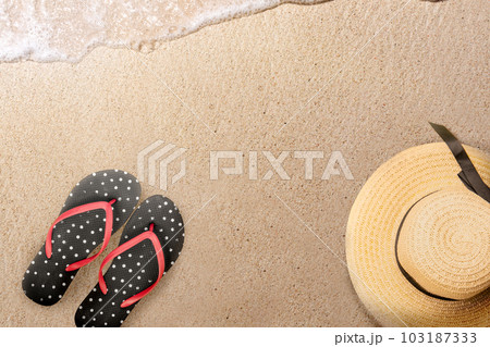 Hat and slipper on the sandy beach 103187333