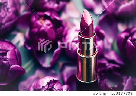 Professional makeup cosmetics, lipstick tube, purple background natural flowers. Beauty concept, decorative professional products 103187803
