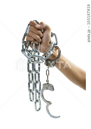 Humans hand with handcuff tied with a chain of...の写真素材 [103187919] - PIXTA