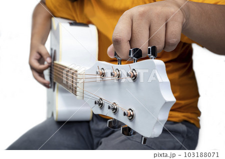 Man tuning guitar string 103188071