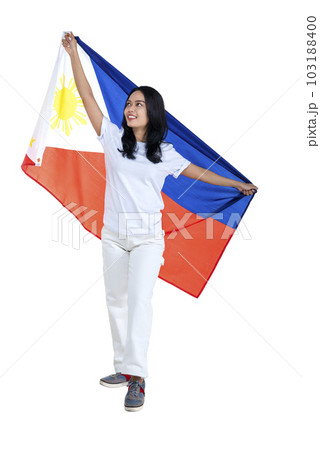 Asian women celebrate the Philippines independence day on 12 June by holding the Philippines flag 103188400