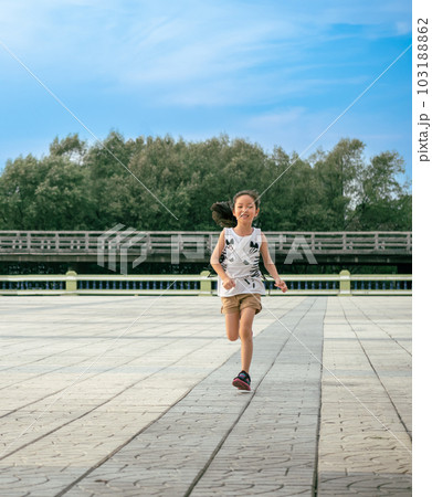 Asian child girl running out door with smile Asian child girl running out door with smile 103188862