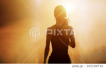 Successful, strong woman overcomes difficulties and runs towards her goals and achievements. Female silhouette on sunrise city background. Success Business Leadership. 103189742