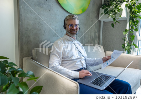Joyous entrepreneur working in a coworking space Joyous entrepreneur working in a coworking space 103192897