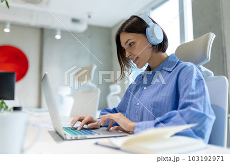 Concentrated corporate worker typing on the portable computer Concentrated corporate worker typing on the portable computer 103192971