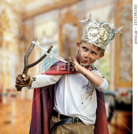 Little boy with a rocker dressed as a prince 103196380