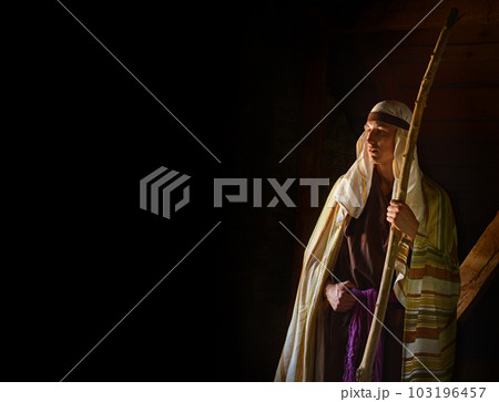 Ancient man with wooden wand 103196457