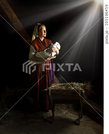 Mary in the stable near the manger with the baby Mary in the stable near the manger with the baby 103196459