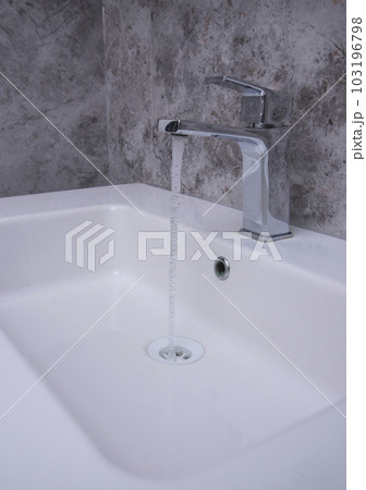 Faucet and water drop close up. Bathroom interior with sink and water tap. 103196798