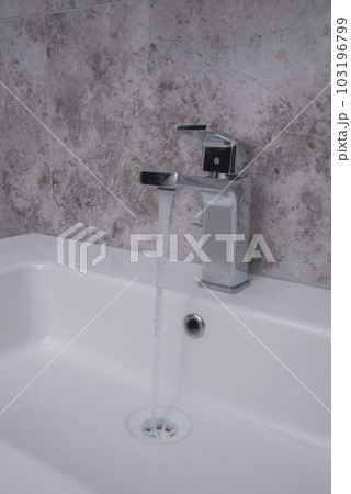 Faucet and water drop close up. Bathroom interior with sink and water tap. 103196799