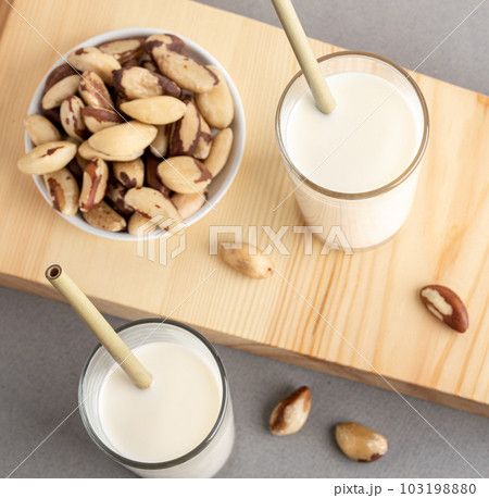 Healthy organic drink. Vegan milk made from brazil nuts. Square format. Top view. Close up. Healthy organic drink. Vegan milk made from brazil nuts. Square format. Top view. Close up. 103198880