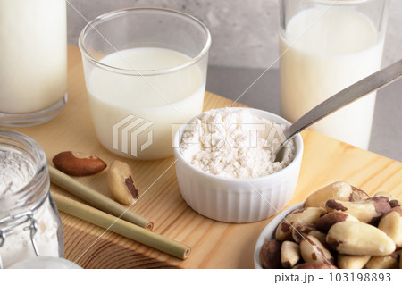 Vegan organic brazil nuts milk from nut powder. Alternative healthy lactose free milk. Top view. Vegan organic brazil nuts milk from nut powder. Alternative healthy lactose free milk. Top view. 103198893