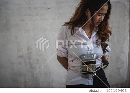 Young woman violence hurting use rope bundle with time bomb, robber criminal rape sexual concept Young woman violence hurting use rope bundle with time bomb, robber criminal rape sexual concept 103199408