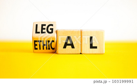Ethical or legal symbol. Businessman turns wooden cubes and changes the word Ethical to Legal on a Beautiful yellow table white background. Business and ethical or legal concept. Copy space. 103199991
