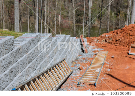 Building retaining block wall being built on new property near newly home Building retaining block wall being built on new property near newly home 103200099