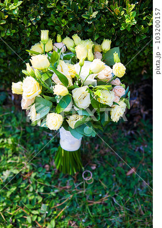 beautiful bridal bouquet lying on green grass beautiful bridal bouquet lying on green grass 103200157